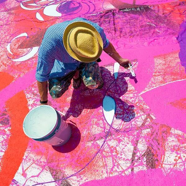 An artist painting the pavement.
