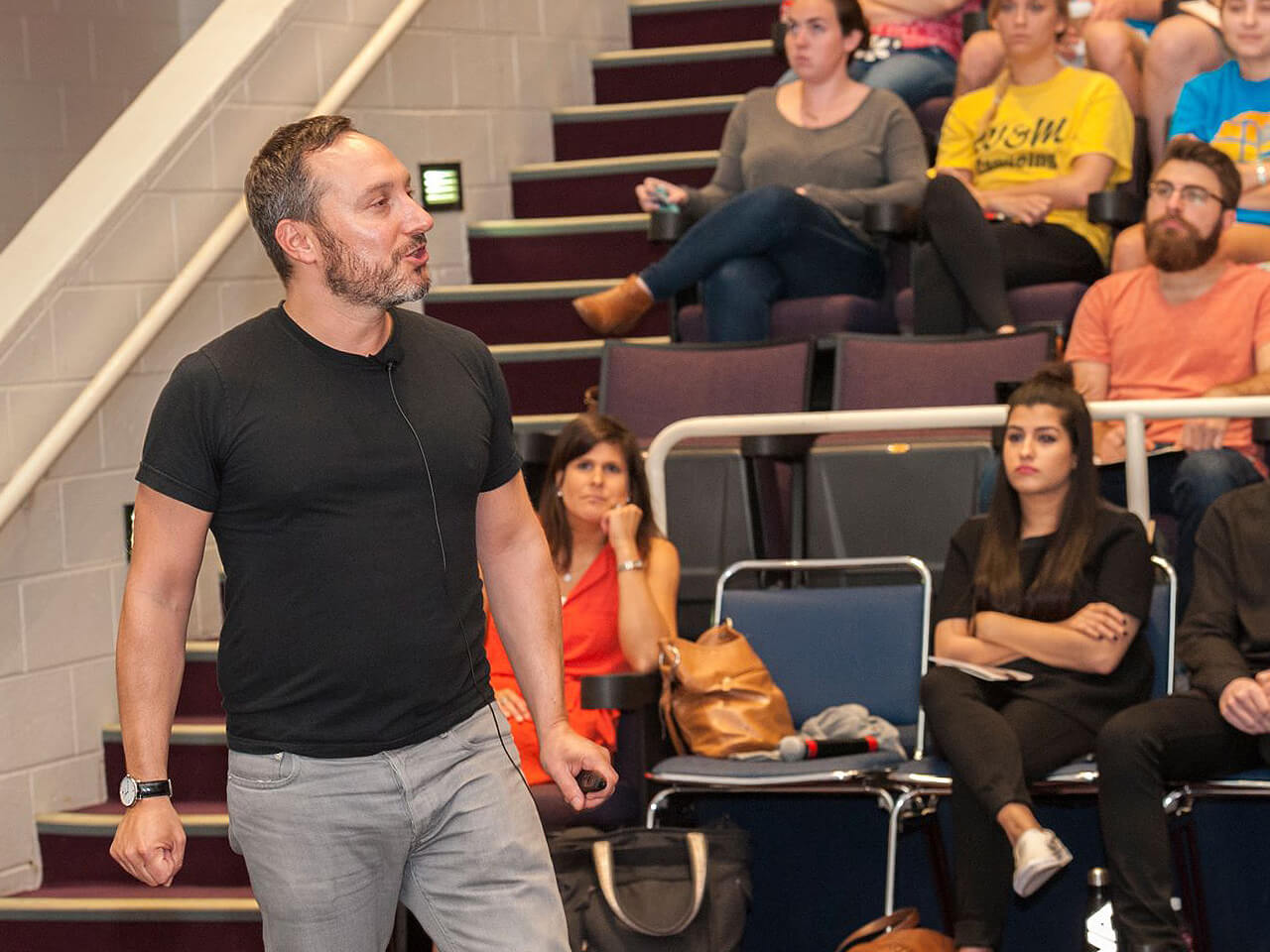 Guest lecturer speaking to large group