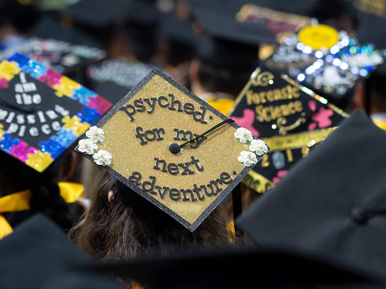 Student wearing decorated mortar board at graduation