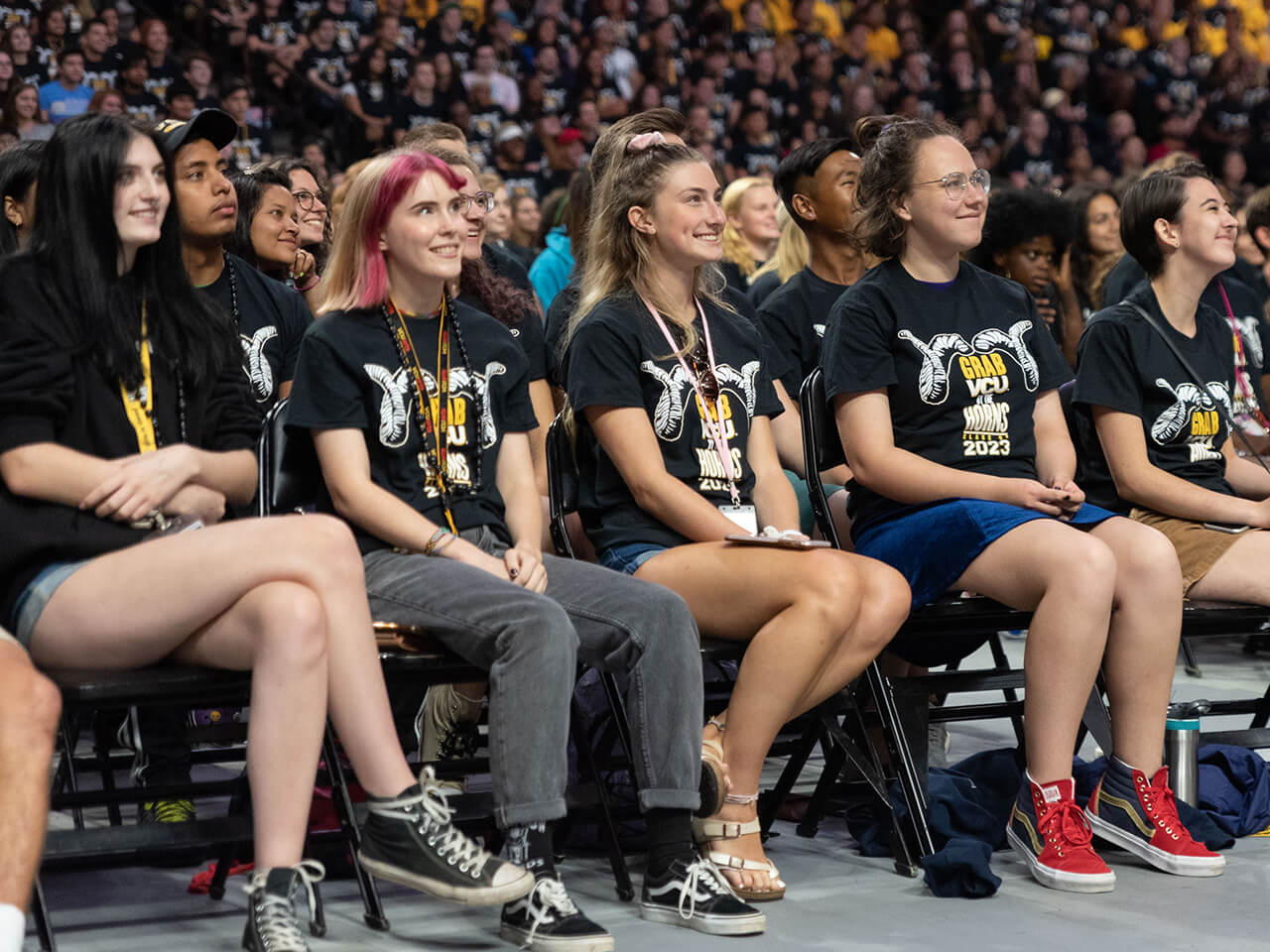 Students in a large group participate in convocation
