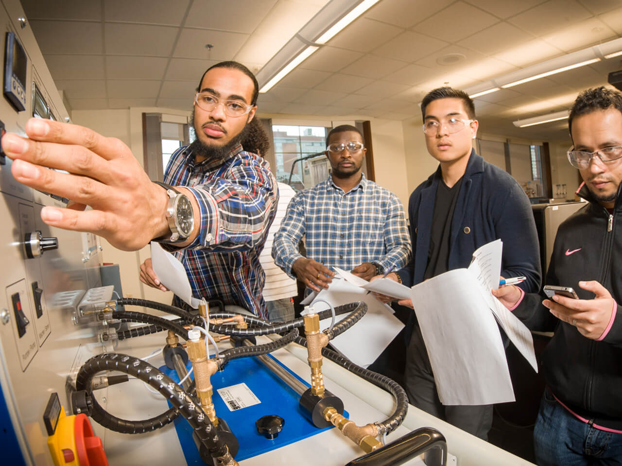 Students working on a machine during class