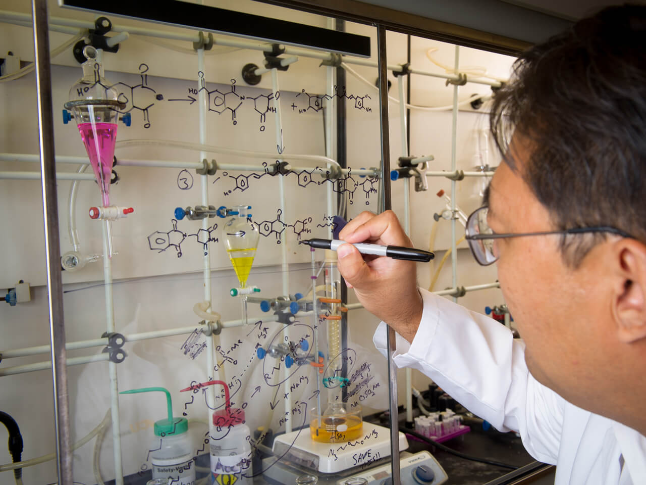 Person in white coat doing research