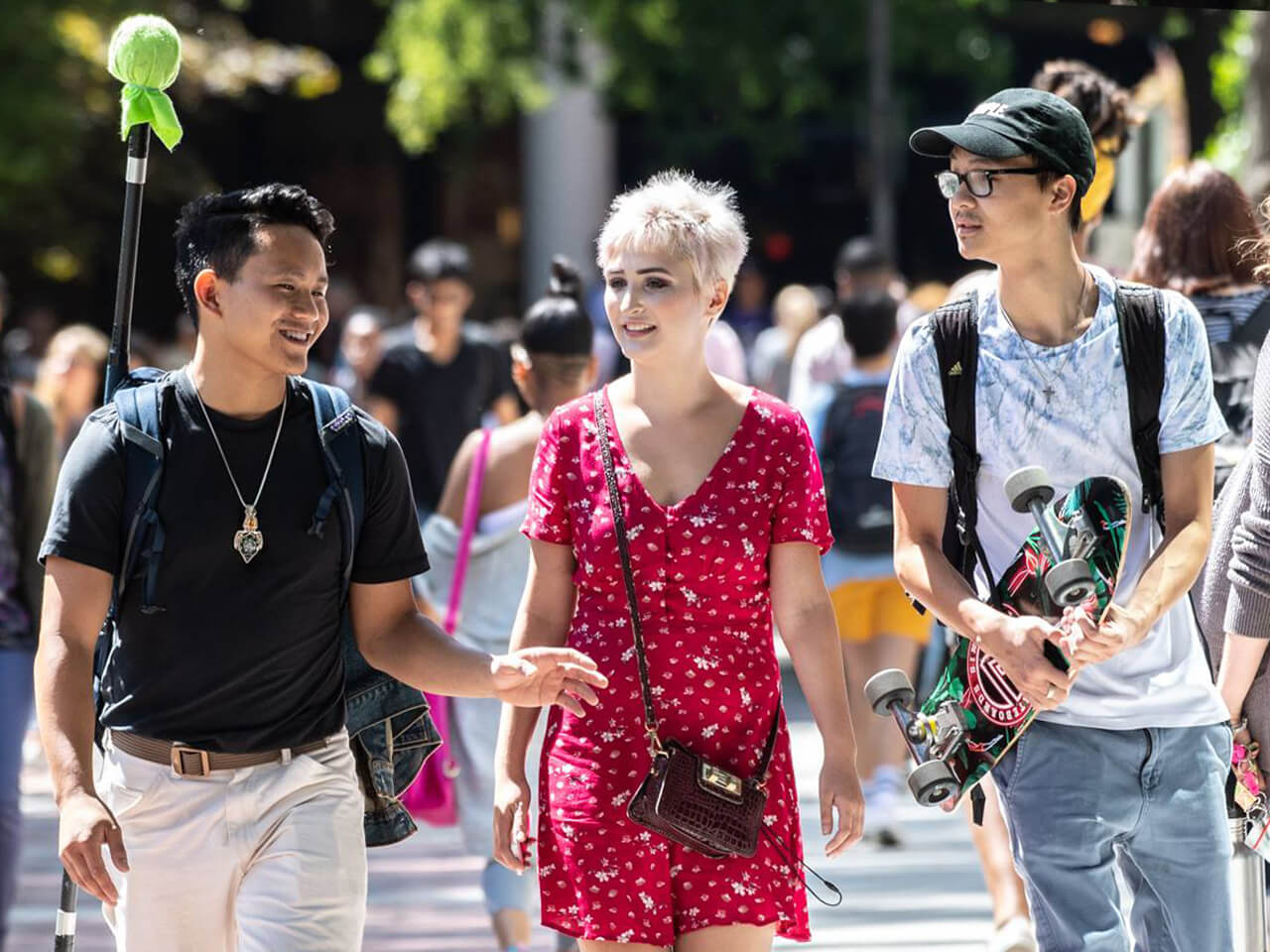 Three students walking together on campus